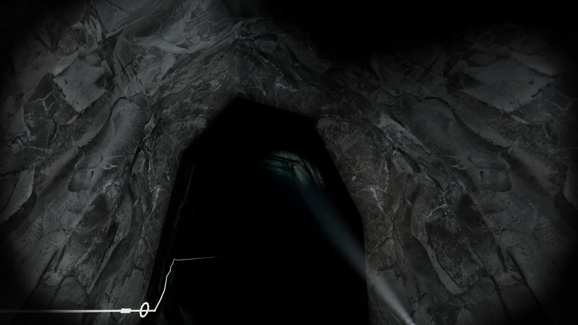 Torch-lit rocky cave passage with a visible guideline leading through the opening